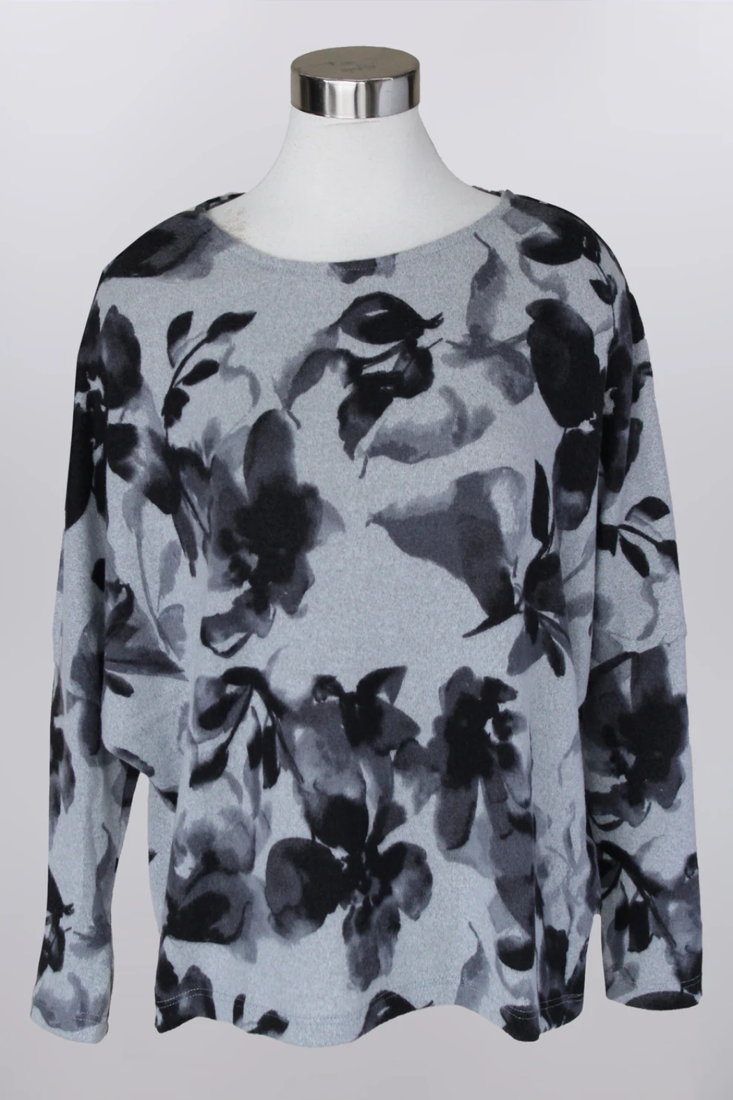 Floral patterned sweater on a mannequin against a white background