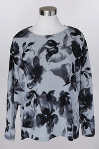 Floral patterned sweater on a mannequin against a white background