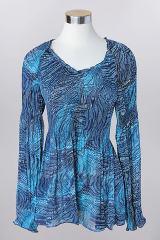 Blue patterned blouse on a mannequin against a gray background